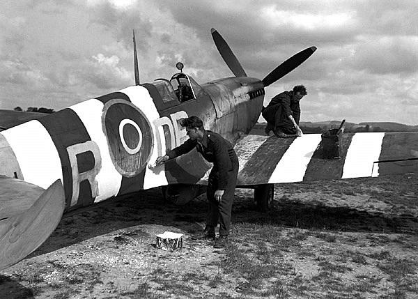 411 Squadron RCAF ground crew members apply invasion stripes to Spitfire Mk IXe DBR serial no RR 201 This aircraft was flown by FL Jack J Boyle