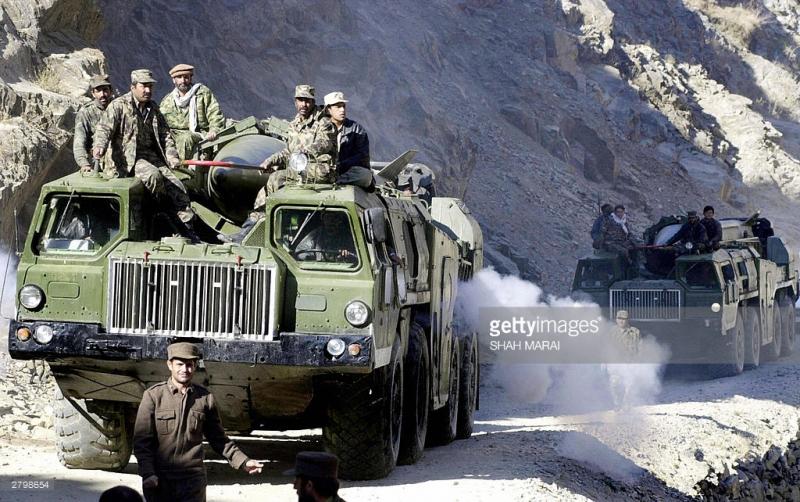 an-afghan-soldier-gestures-while-his-colleagues-sit-on-a-heavyvehicle-picture-id2798654-1.jpeg