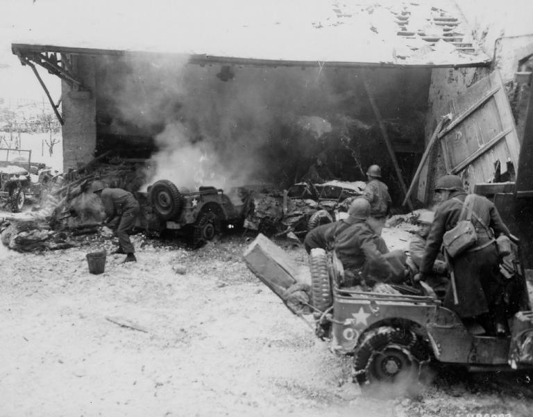 Burning jeeps from the 104th Inf Rgt, 26th Inf Div after a German indirect fire attack at Wiltz,