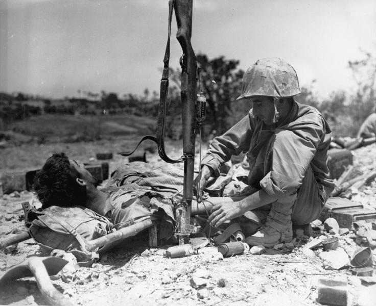 blood

1945 Okinawa, a US Marines wounded a medic transfused using his Garand rifle as infusion stand